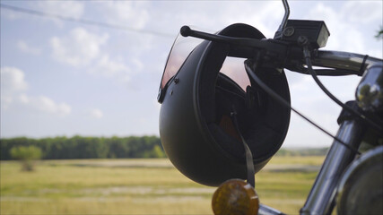 Motorcycle scooter gas and brake handle with chrome and black helmet with visor. Black helmet...