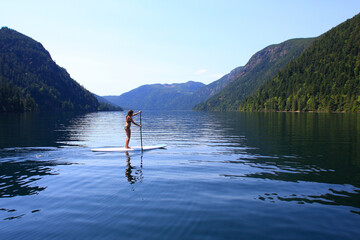 Standup Paddle girl in summer on a lake