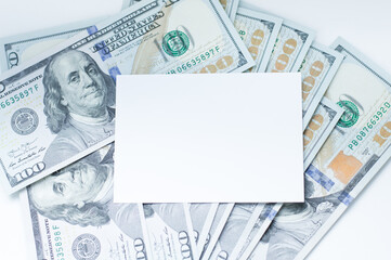 white blank business card on dollars background, template layout, close-up business card