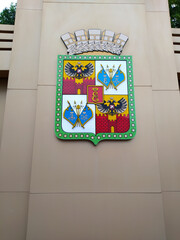 The coat of arms of Krasnodar at the exhibition stand. Photo