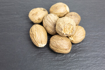 heap of whole nutmegs - myristica fragrans