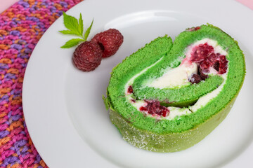 green matcha roll cake with cream cheese and fresh raspberry