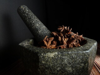 star anise in a mortar ready to be pound