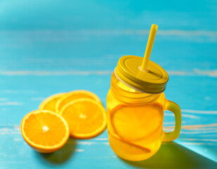 Cold drink with oranges in jar