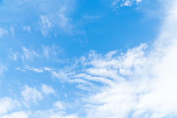 Naklejka na ściany i meble Blue sky with beautiful natural white clouds. Space for text. Background.