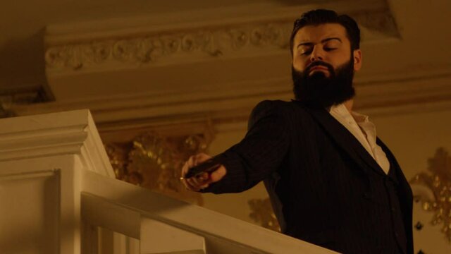 a brutal man with a beard and a machine gun