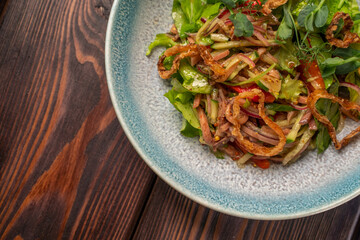 Delicious salad with boiled beef tongue, cucumber