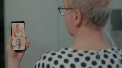 Senior patient speaking with family on videocall in hospital ward at emergency healthcare facility. Sick old man with nasal oxygen tube and oximeter using smartphone to relax from surgery - Powered by Adobe