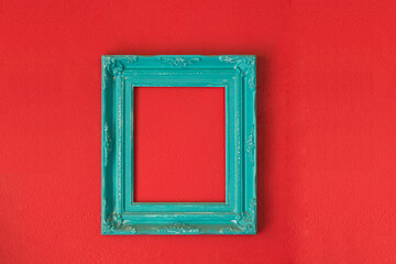 Realistic light blue picture frames on red cement background.