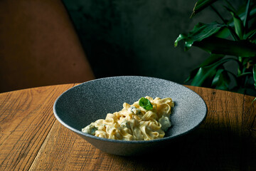 Cheese creamy fettuccine pasta in a gray plate. Italian cuisine