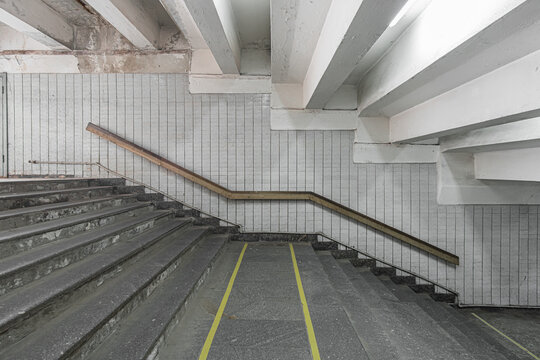 Stairs To The Shabby Underpass Or Subway Station. Side View Of Empty Stairs With A Wall Lined With Ceramic Glossy Tiles.