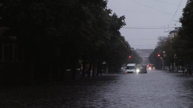 Car driving through a flooded street after the strong rain