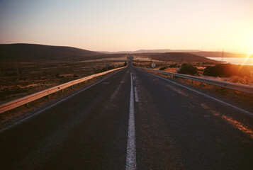 Empty country road background on sunset.