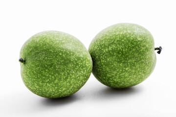 Young green walnut isolated on white background