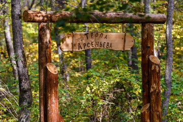 Sikhote-Alin Biosphere Reserve. Wooden entrance to the Arsenyev trail. A sign with the name of the ecological route in the forest.