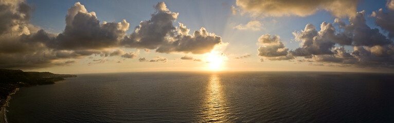 Aerial view of the coast of the Gods, setting sun over the sea, Calabrian coast, Zambrone. Calabria. Italy. Clouds and gods rays. Sunset