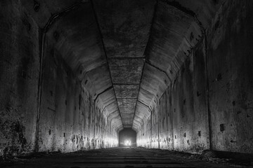 Empty abandoned railway dark tunnel with light in the end. - obrazy, fototapety, plakaty