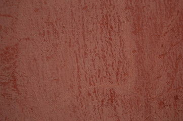 pale red background with streaks of paint. Wall, surface, color, background, texture, streams