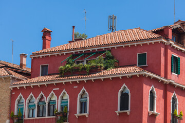 Typical venetian building. Red walls with white gothic windows