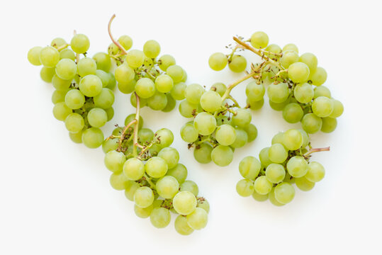 Bunches of grapes on a white background. Green grapes. 