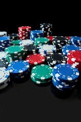 Stack of Casino gambling chips isolated on black reflective background