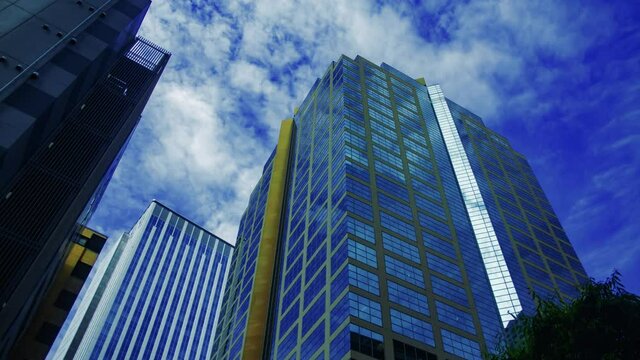 A timelapse of clowd at the building in the business town wide shot tilt