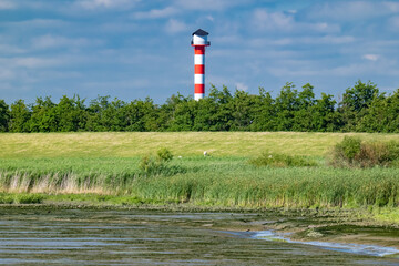 Glückstadt, Germany. The river Elbe with marshland and lighthouse.