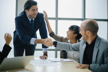 Smiling male boss talking to business team business. Technology and office concept.