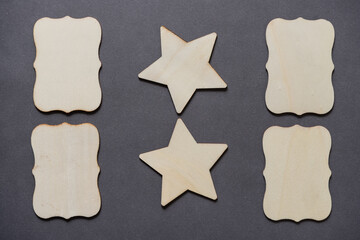 plain, untreated wooden labels and stars on gray paper background