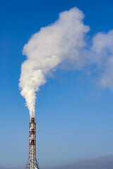 Smoke from a chimney against a blue sky