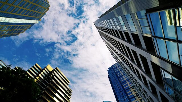 A timelapse of clowd at the building in the business town wide shot panning