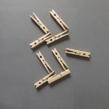 wooden clothes pins on a medium gray background