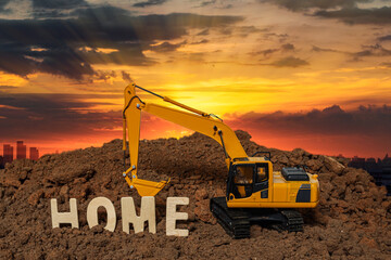 Home concept and  Excavator digging the soil In the construction site area city  on sunset...