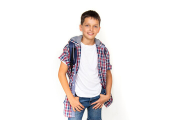 Boy teenager 11 years old schoolboy looking at camera on white background with backpack and...