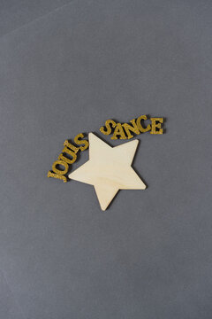 the word "jouissance" and a star shape or silhouette on gray paper