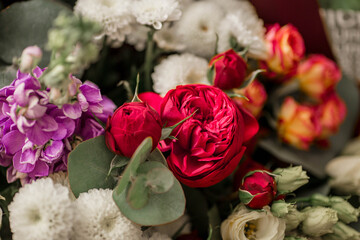 Top view of beautiful colorful bouquet. Fresh flowers background. Сombination of white chrysanthemums and red peony roses.