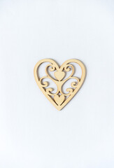 isolated laser cut untreated wood heart on a light background