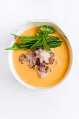 cream soup with octopus and herbs