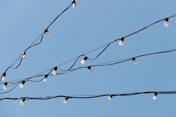 rope lights strung across a blue sky