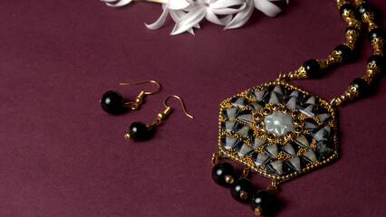 Indian traditional antique or retro style pendant on black background.
