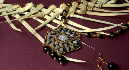 Indian traditional antique or retro style pendant on black background.
