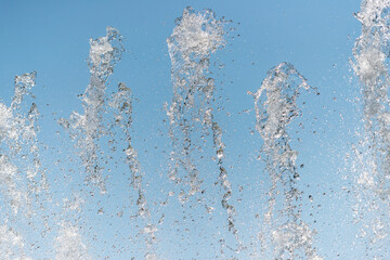 stop action photograph with jets of fountain water against a blue sky
