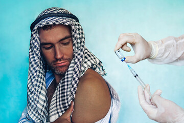 man patient in Arab clothes at a doctor's appointment. Vaccination of the Middle East countries....