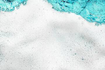 White foam blue water background closeup, sea or ocean foam wave pattern, froth bubbles texture, soap spume backdrop, cleaning soap sud, lather surface, soapy detergent, laundry, foamy bathtub, shower