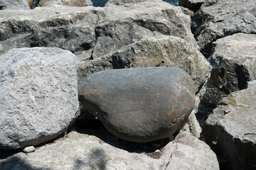 big smooth stone among large rough stones