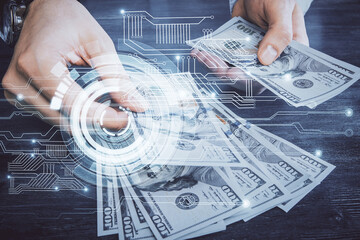 Multi exposure of technology drawing hologram and us dollars bills and man hands. Data concept