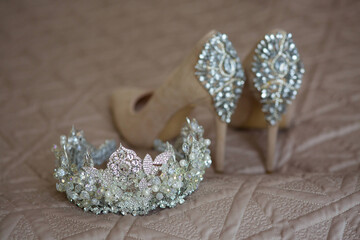 A luxurious tiara for a bride or princess close-up. Shoes in the background. Jewelry accessories.