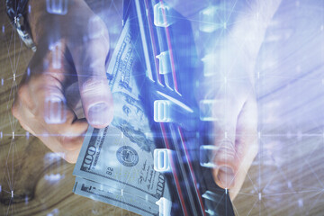 Plakat Double exposure of technology drawing hologram and us dollars bills and man hands. Data concept