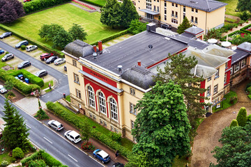 Aerial view of historical hotel in Bad Schandau in Saxony, Germany, with flat roof and parking place next to hotel - obrazy, fototapety, plakaty
