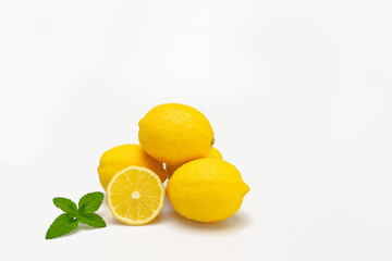 Isolate lemons and mint leaves on white background.Preparation ingredient for skin care scrub and lotion. Making lemon juice,easy and tasty refreshing drink quenches thirst well on a hot summer day.